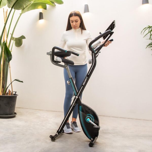Imagen 3 Bicicleta estática plegable DrumFit X-Cycle 1500 Neo Pro con volante de inercia de 1,5 kg, frenado magnético, sistema Silence Fit y pantalla LCD.