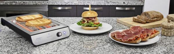 Imagen 6 Tostador plano horizontal de 900 W con acabados en acero inoxidable. Cuenta con 3 resistencias de cuarzo, 6 niveles y bandeja recogemigas para un uso eficiente.